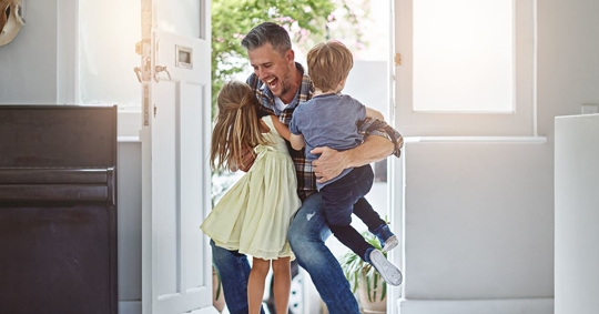 Father hugging both of his children after modifying custody order.