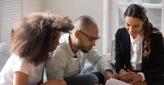 Three people reviewing a prenuptial agreement