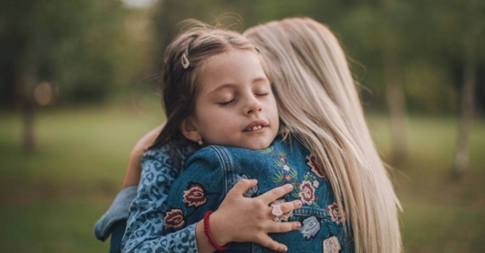 mom hugging daughter