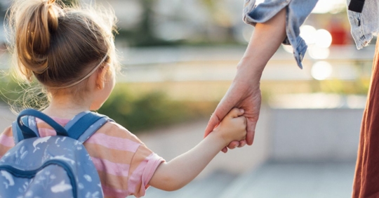 Mom holding daughters hand