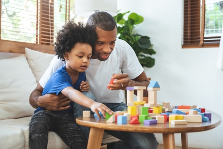 father and son playing with blocks