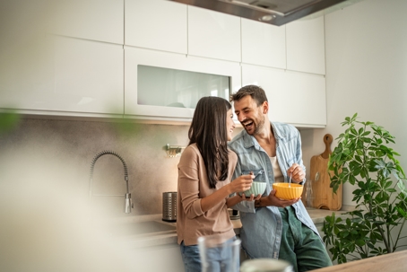 happy couple talking in the kitchen